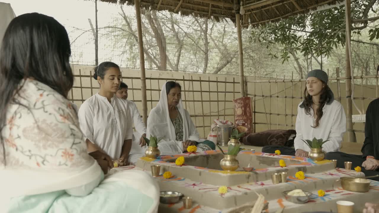 Participants sitting around decorated Havan Kunds at the ASY gathering
