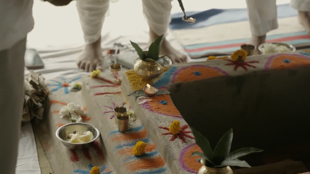Square, stepped Havan Kunds with a recessed centre, flowers, coloured decoration and brass vessels